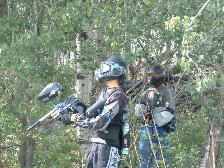Two players covering each other in the trees